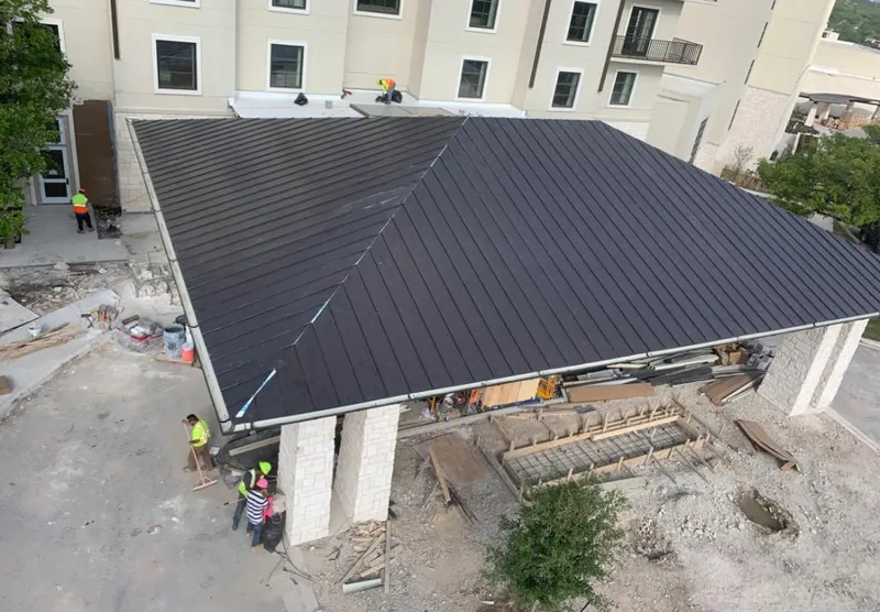 Metal roofing installation team working on a commercial building in North Bend