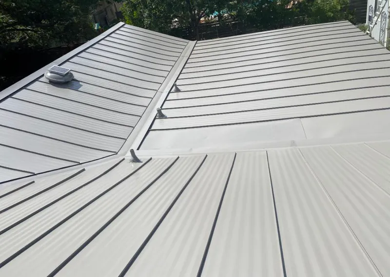 Solar attic fan installed on a metal roof for Roof Ventilation in North Bend